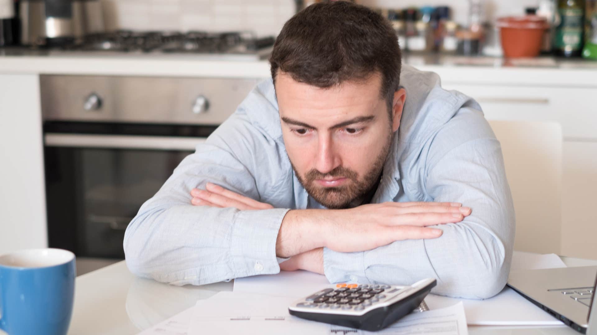 man stressed about being the protector doing bills