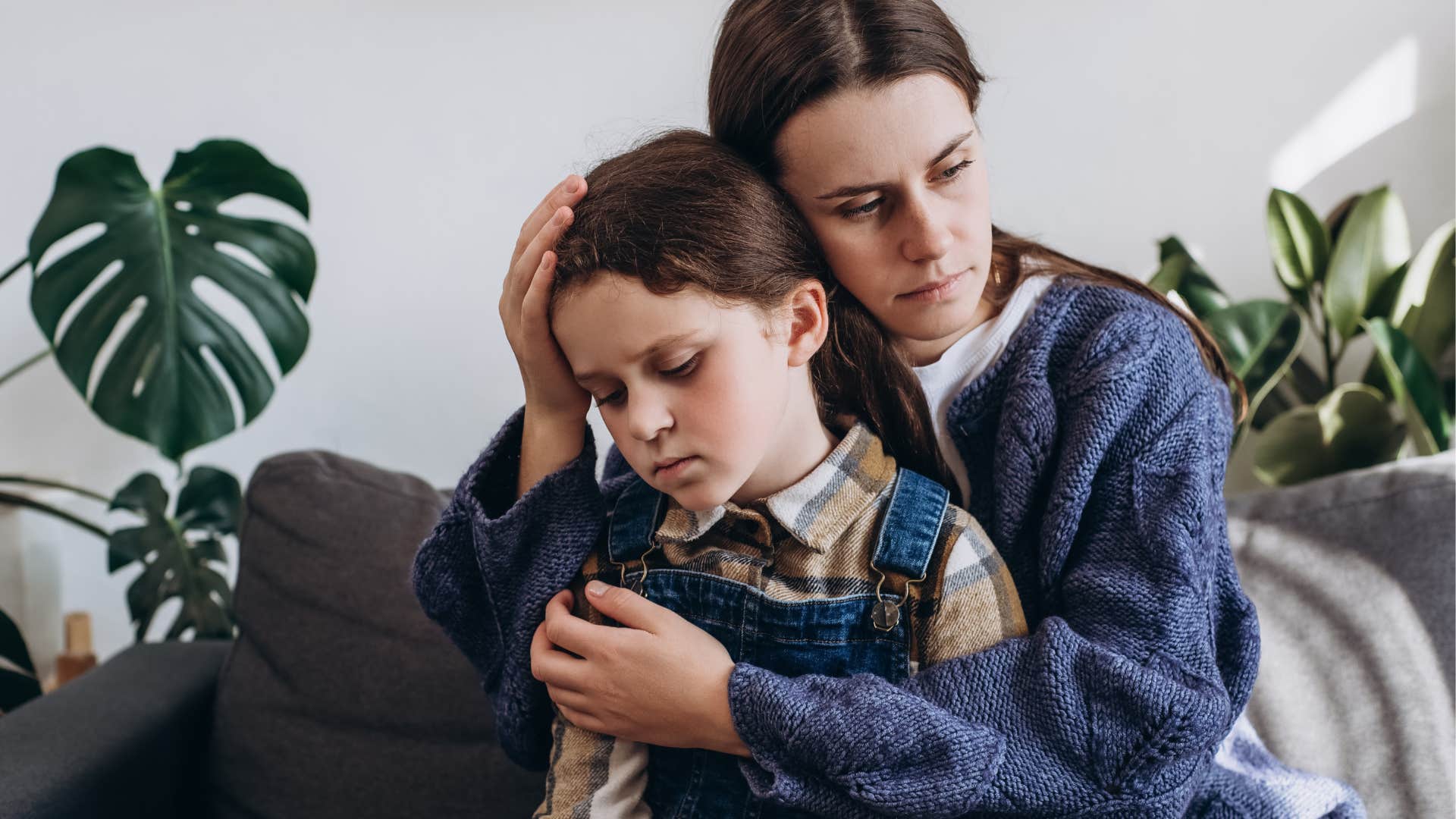 Woman being a great parent and hugging her sad daughter.