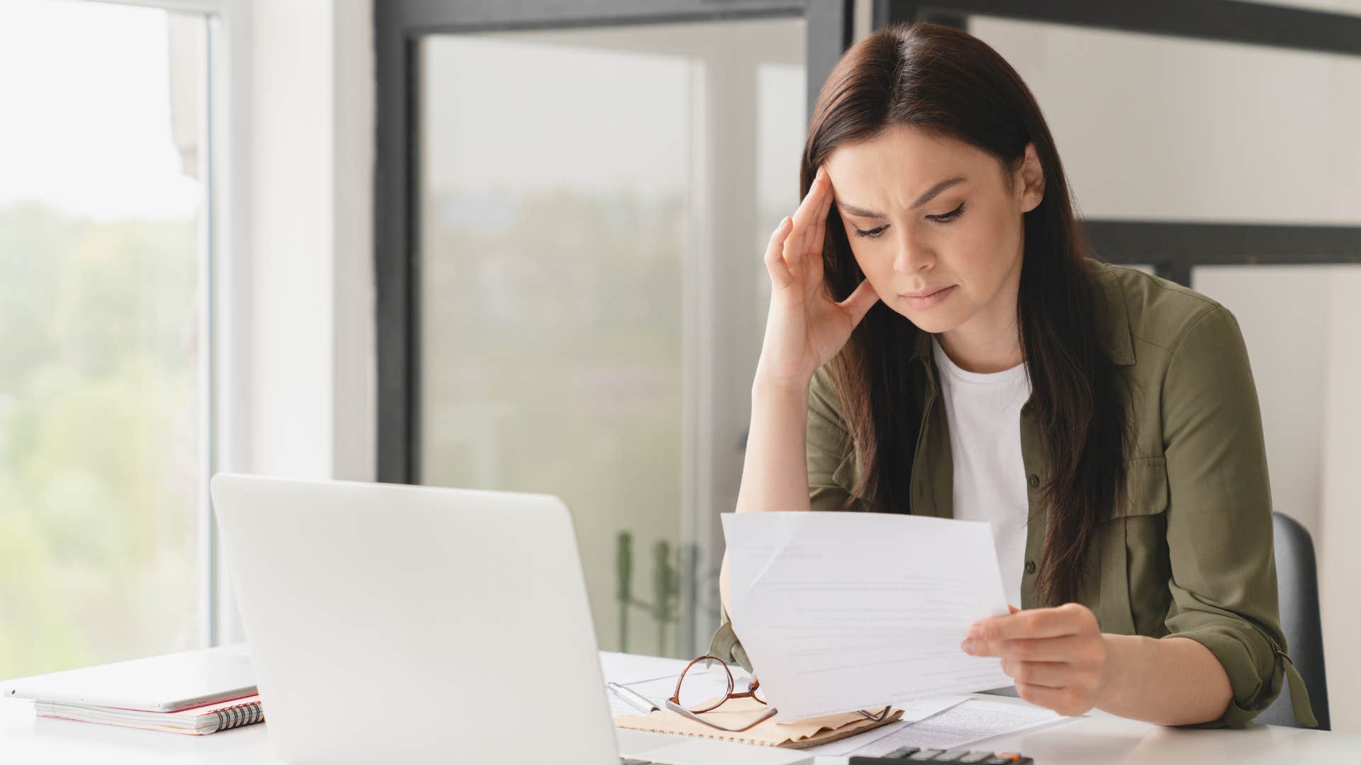 Stressed woman reading a paper about starting a business.