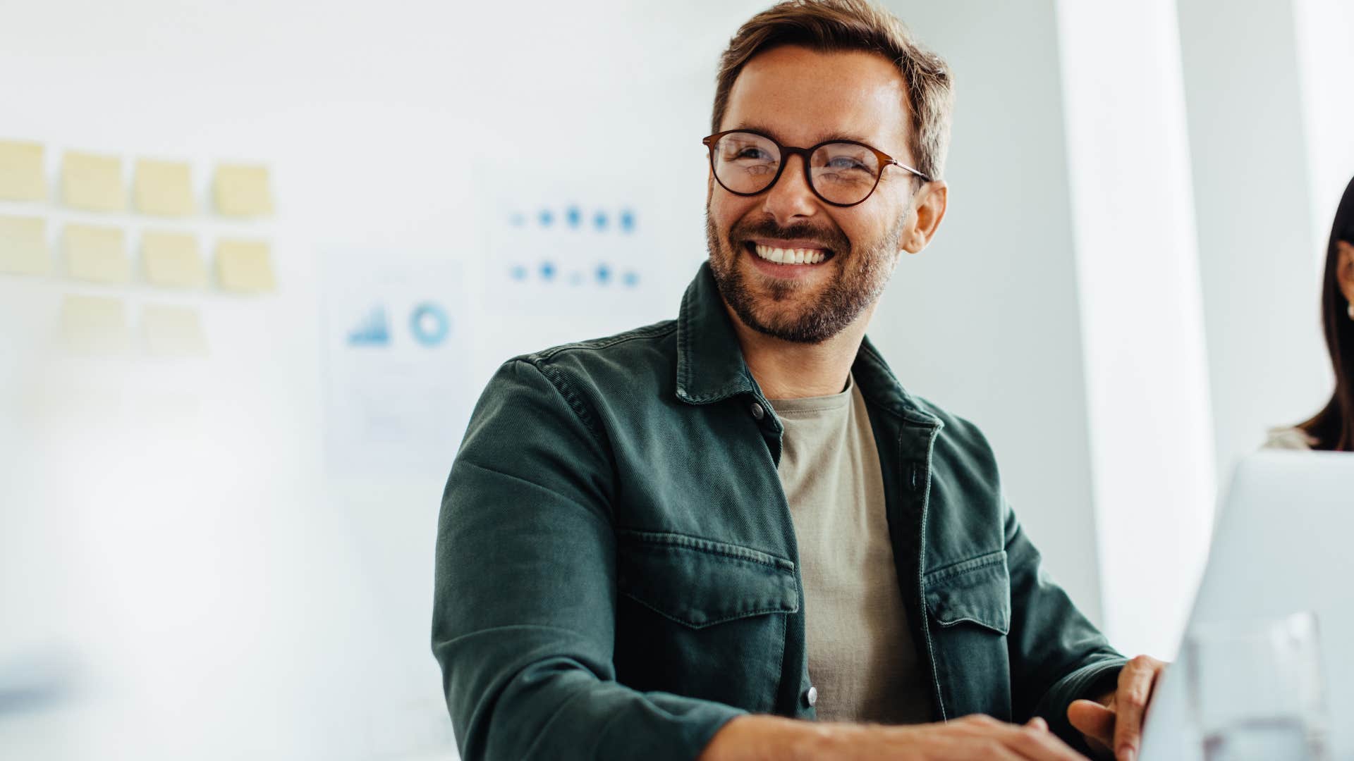 Man with toxic positivity smiling in a work meeting.