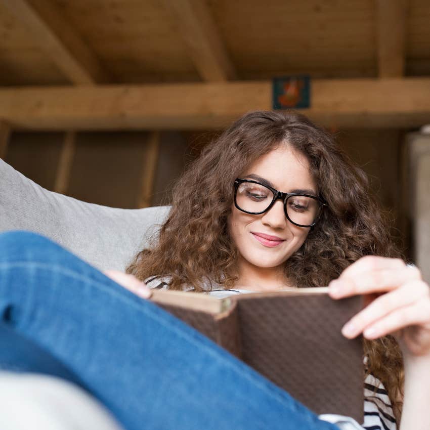 woman smiling reading book