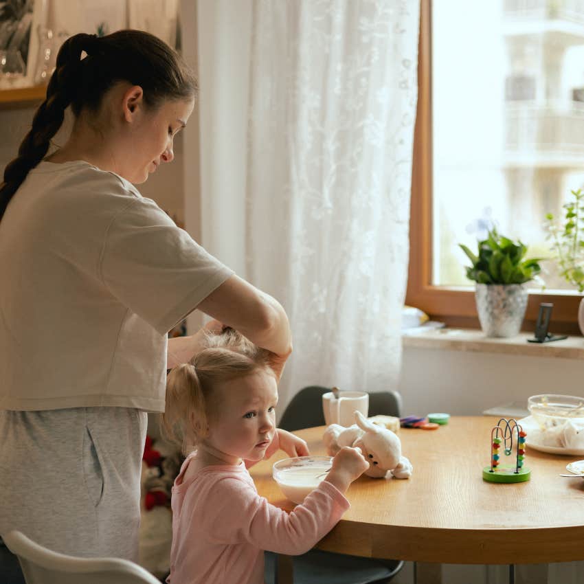 woman done passing down polite lies fixing daughter's hair