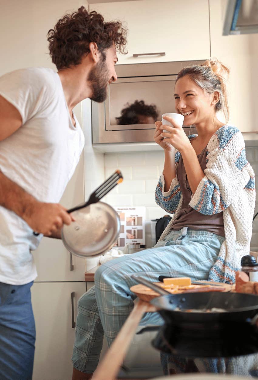 Couple immersing in a new culture by cooking because they love to travel but can't afford it
