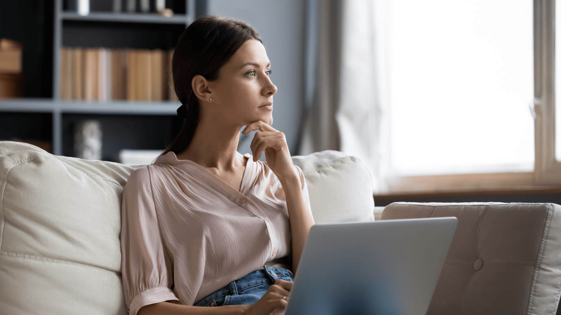 woman sitting on couch thinking about life's questions