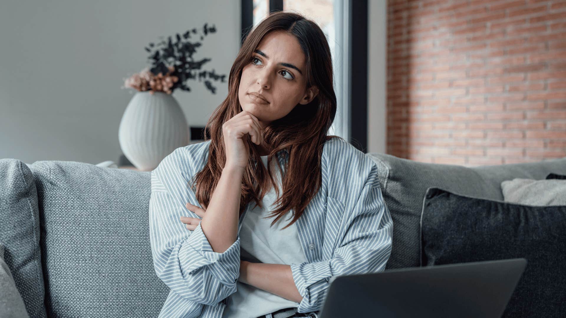 woman with laptop thinking about life's questions