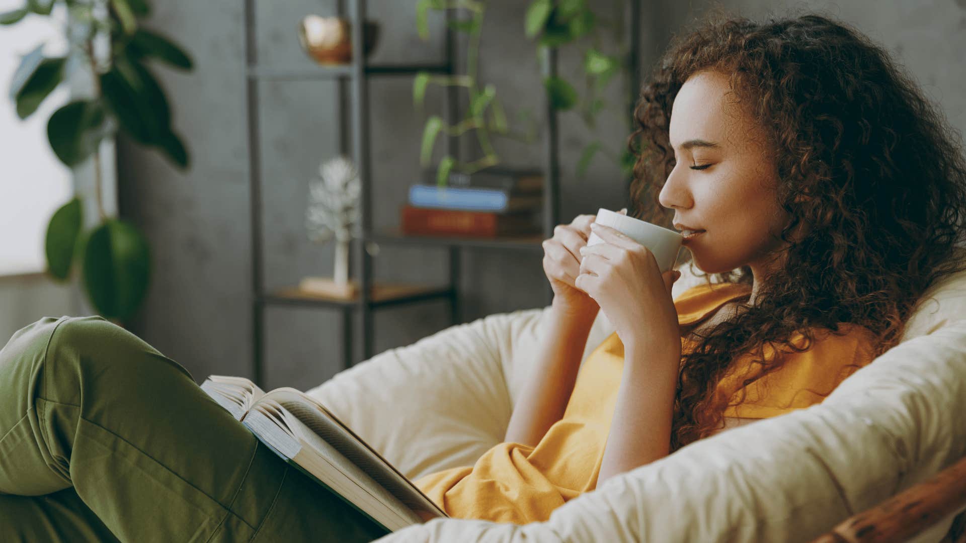 woman taking a break in between her busy schedule by relaxing with coffee and reading
