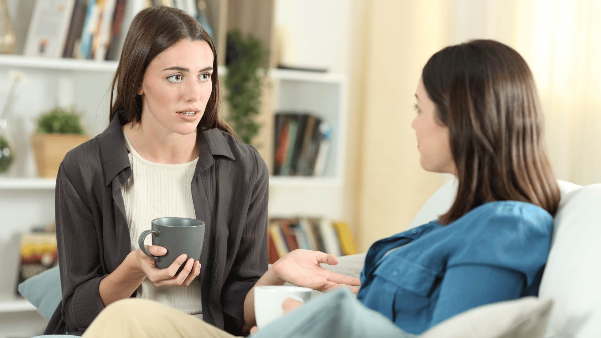 woman cutting off drama by having coffee with her friend and sitting down to talk about serious topic