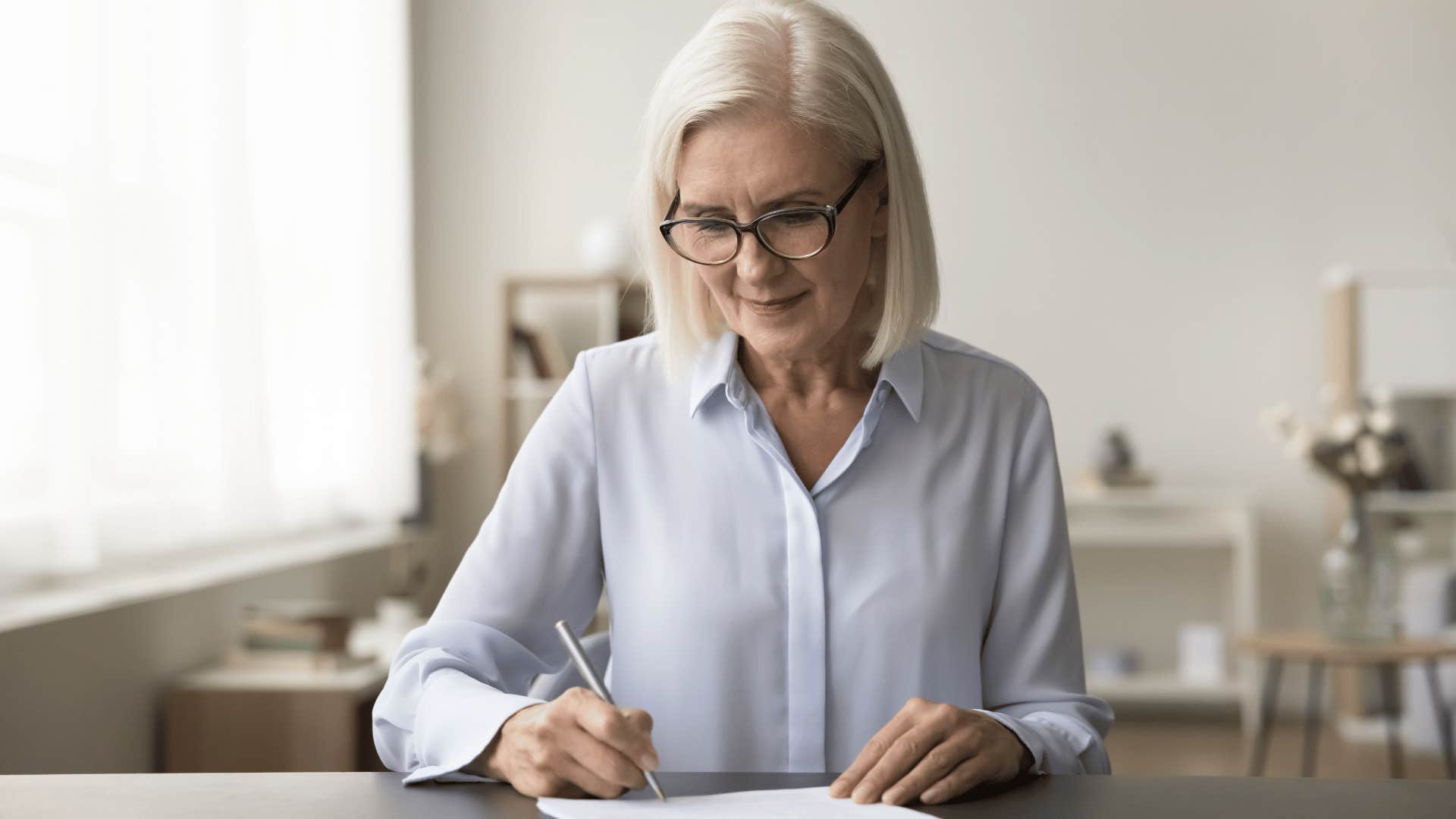 woman doing low-energy hobby of calligraphy