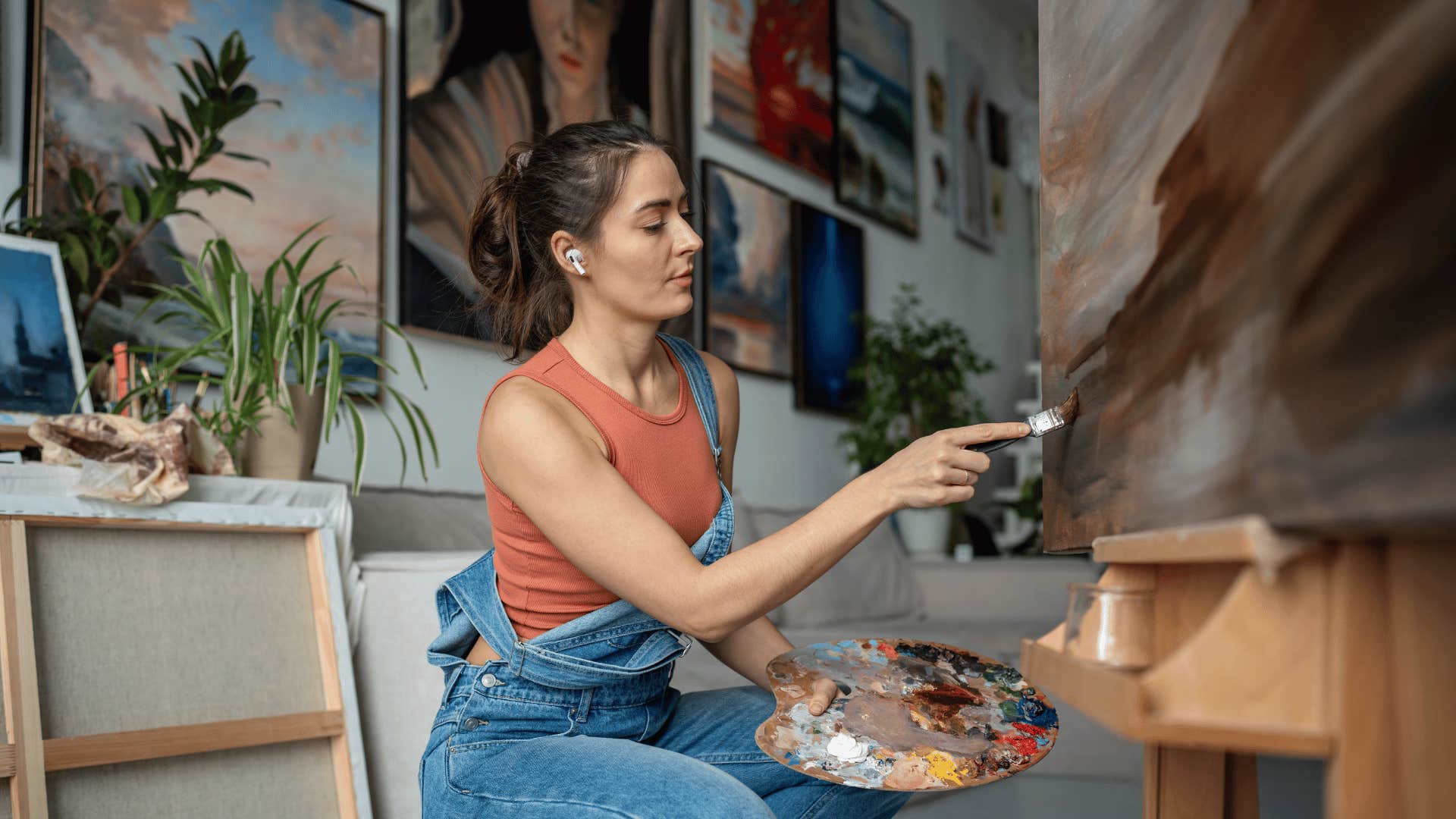 woman doing low-energy hobby of painting