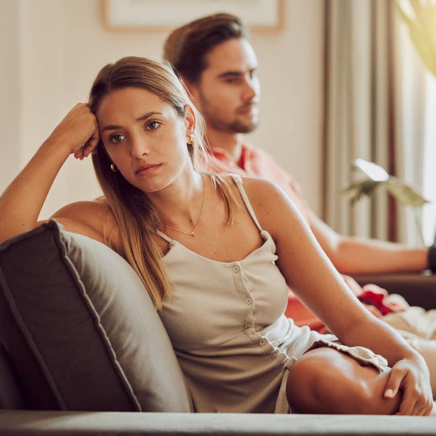 upset woman who hates male dating rituals sitting next to man