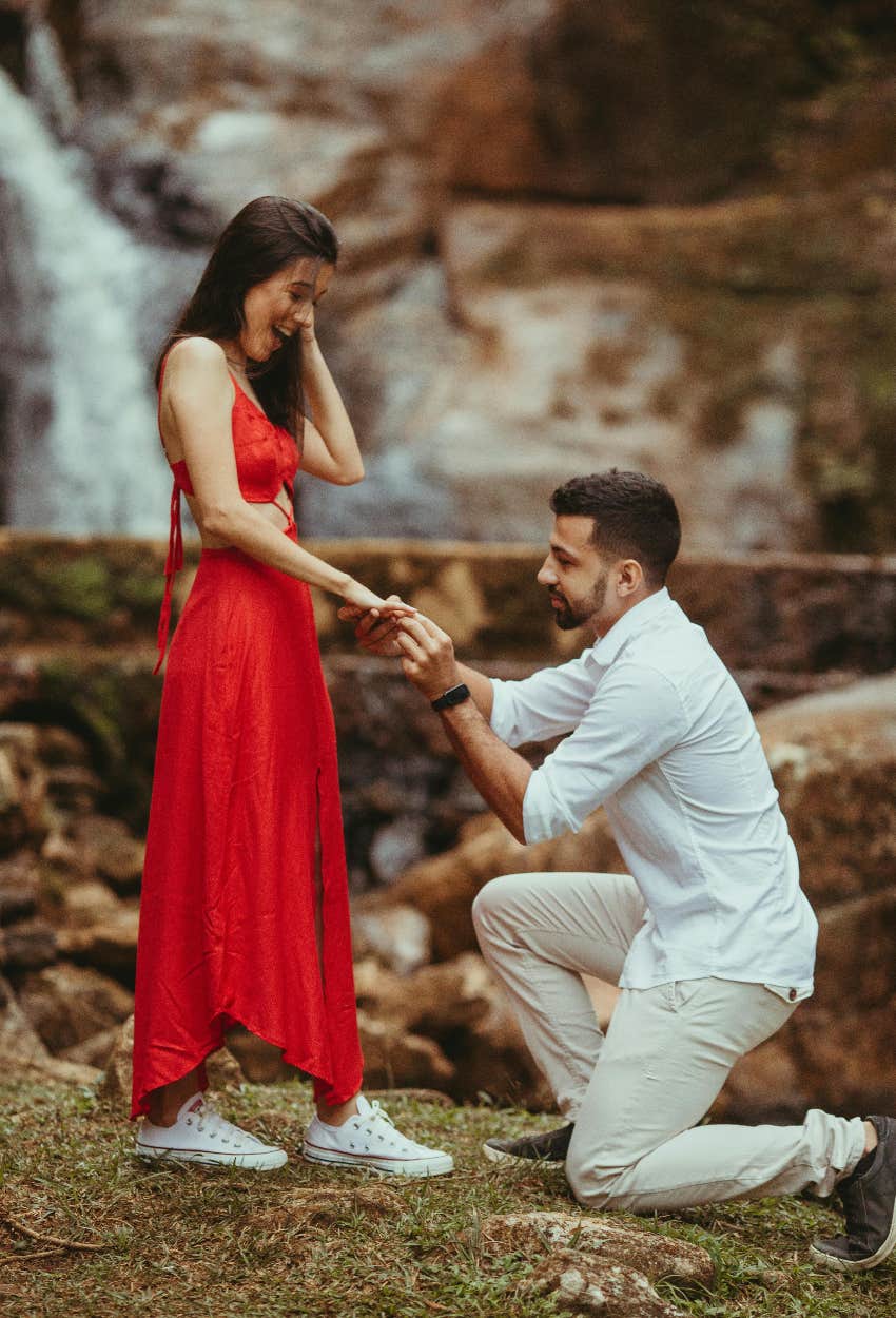 man proposing to his girlfriend with engagement ring that isn't made of real diamond