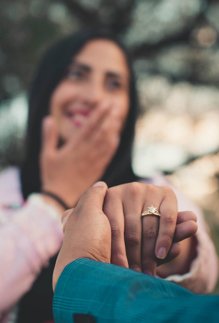 man proposing to his girlfriend who didn't tell her the engagement ring wasn't made with real diamond