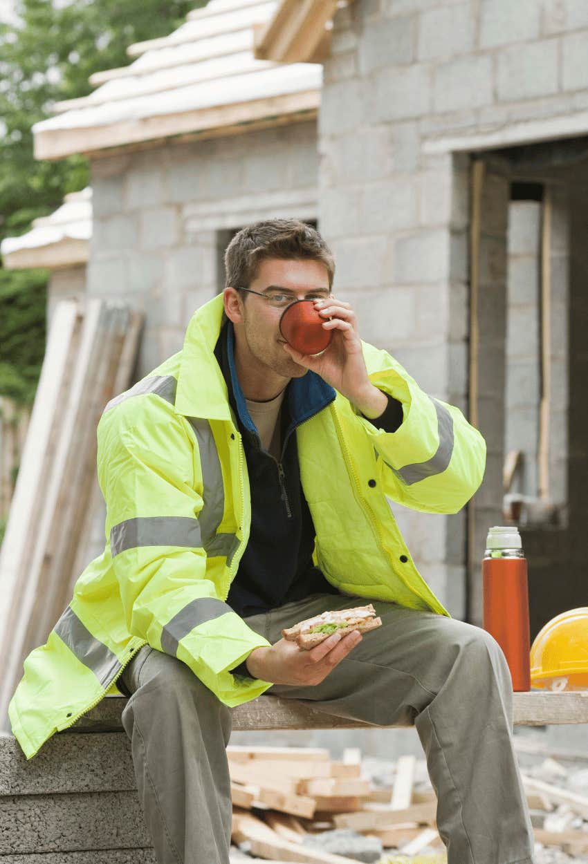 Man's co-worker eating a sandwich after complaining about the man's homemade lunch