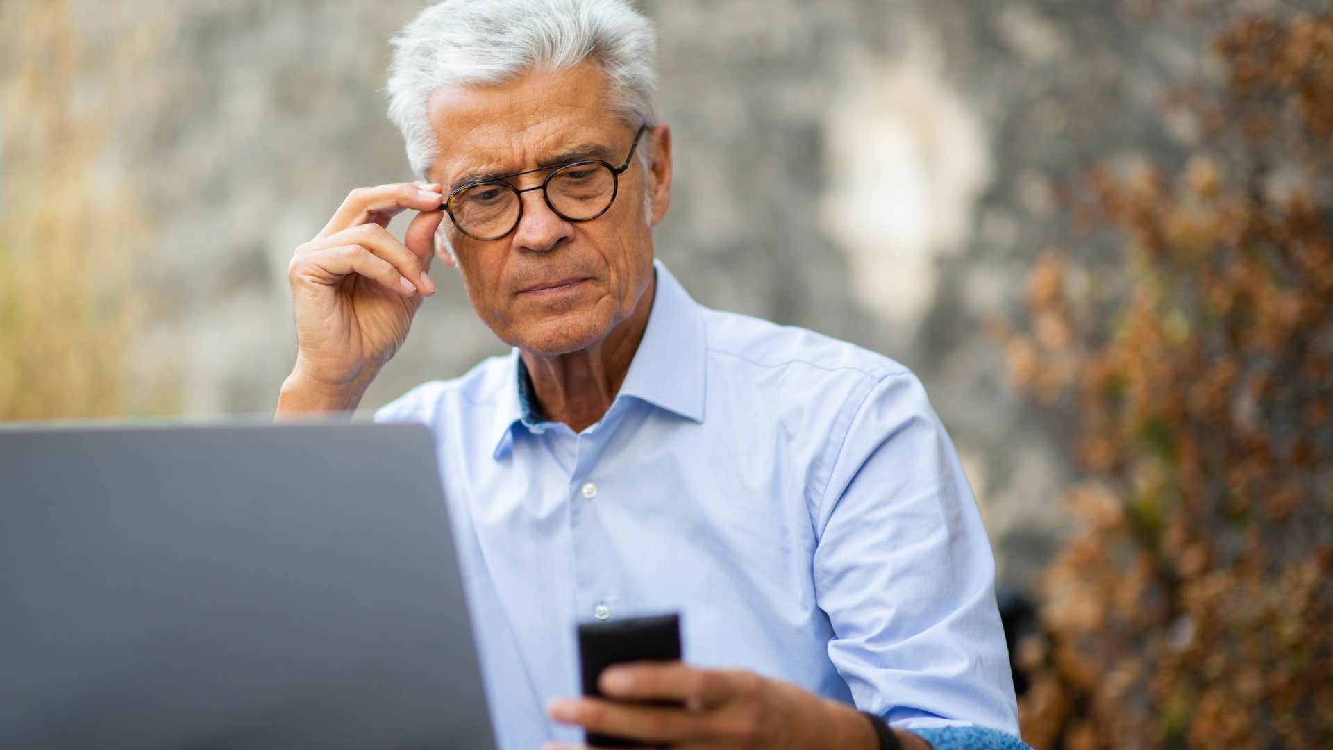 Confused man looking at AI photos and videos on his phone. 