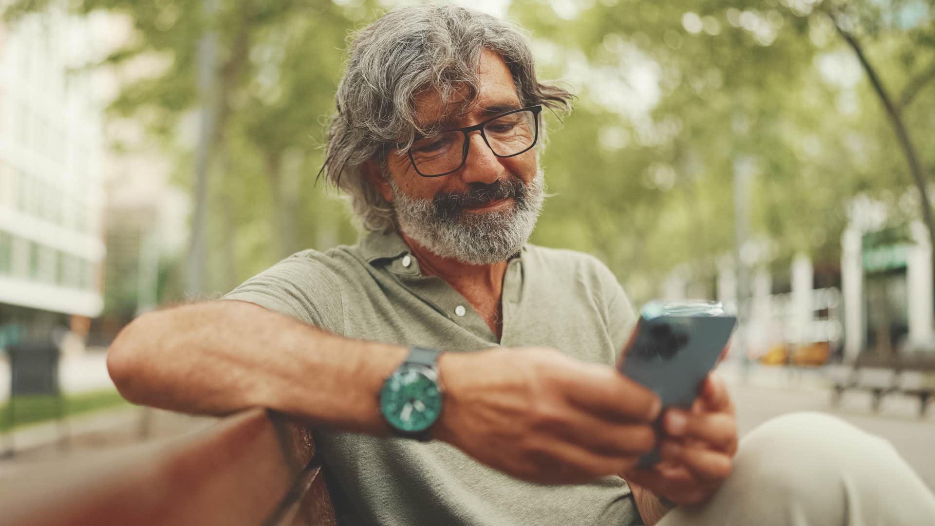 Showing a baby boomer man texting about digital literacy on his phone.