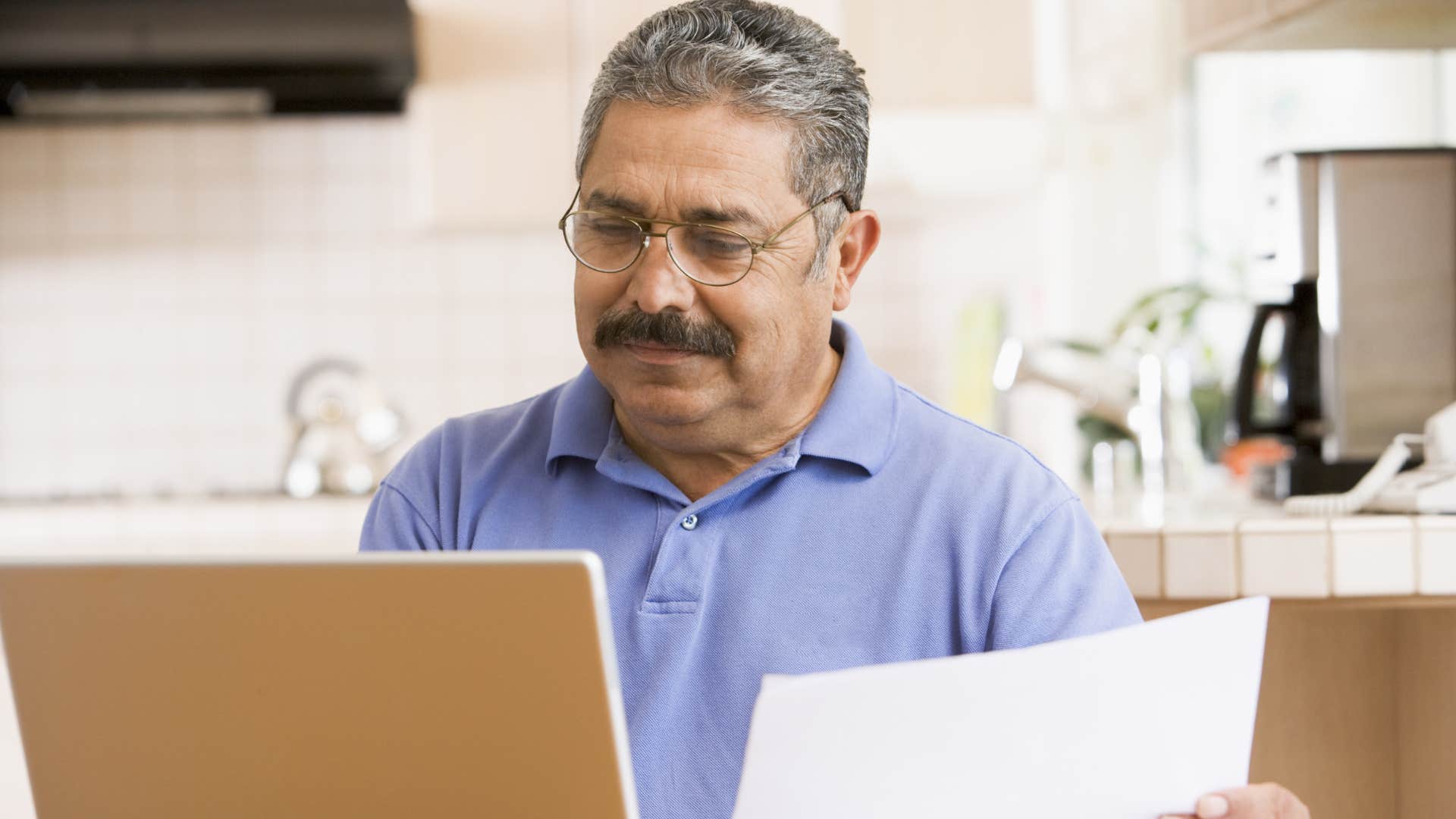 Man typing about how hard work doesn't always equate to success on his laptop.