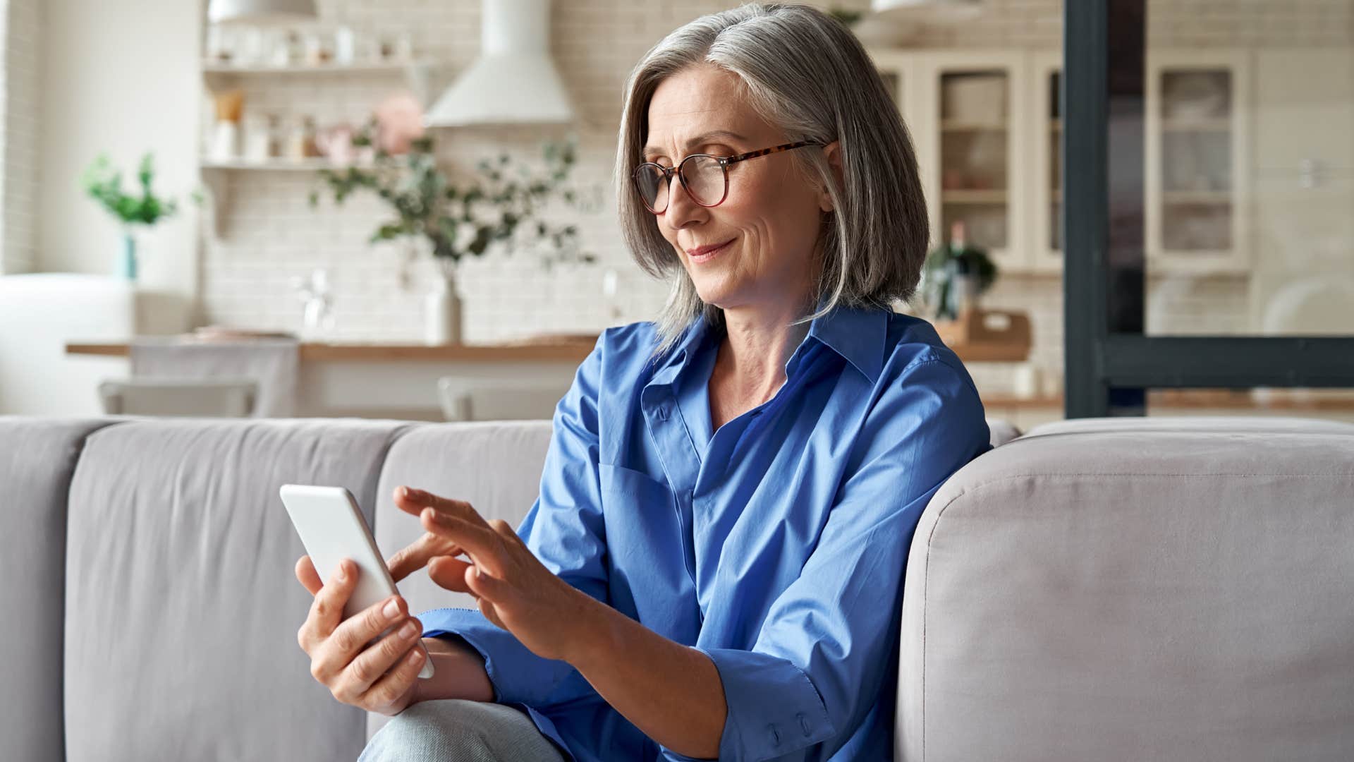 Baby boomer woman doing online banking on her phone.