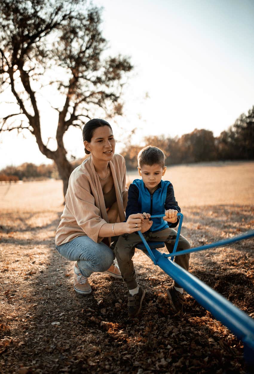 Mom protecting her son at the playground after another kid bullies him
