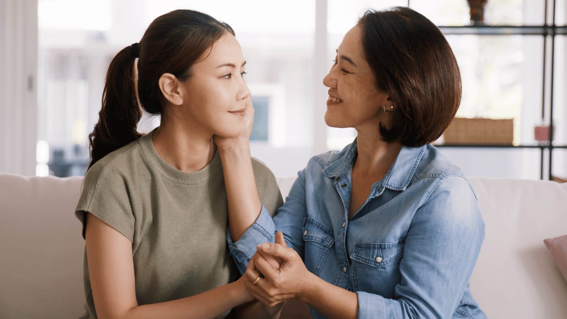 mom showing affection to daughter and caressing cheek
