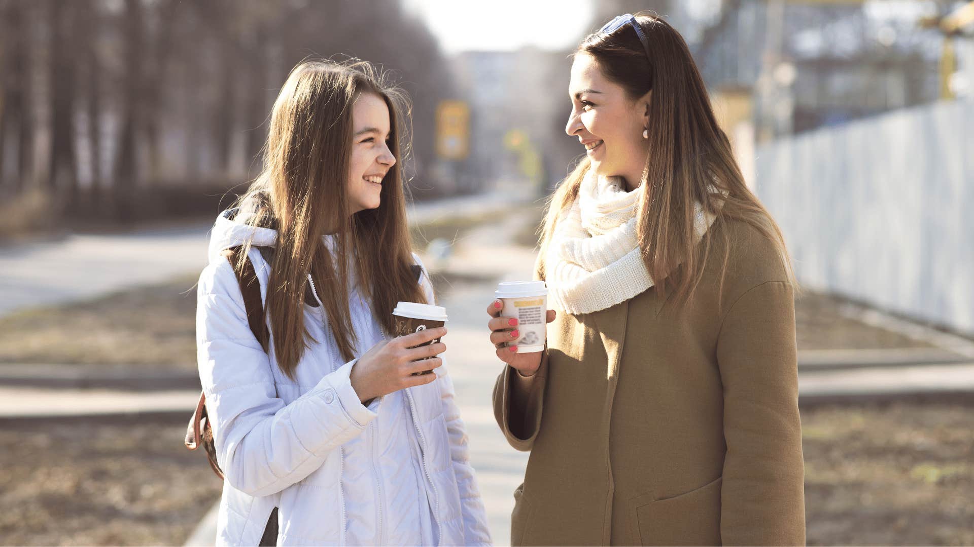 mom talking to daughter over cup of coffee and showing interest in her passions