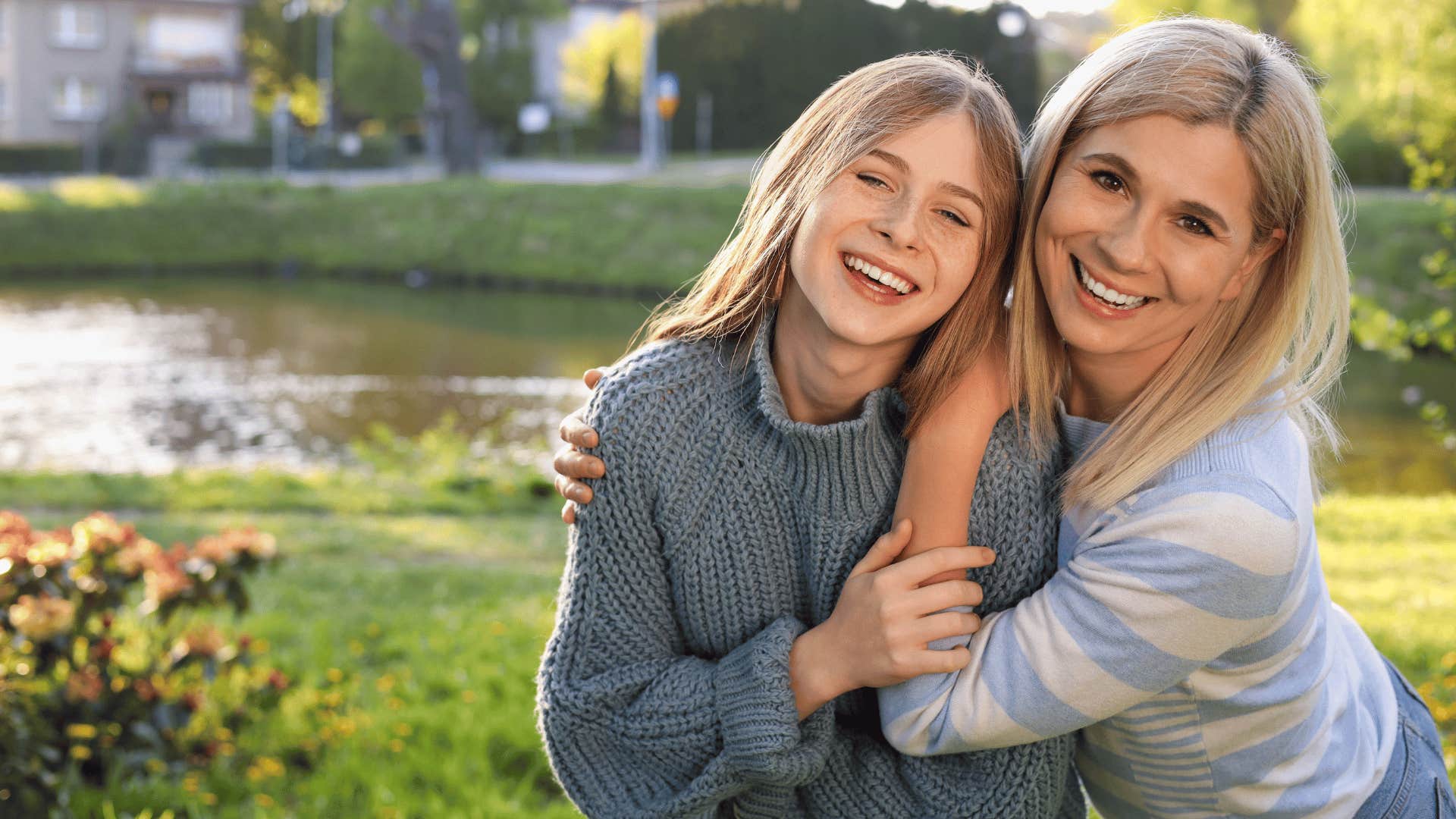 mom taking her daughter outside and hugging her 