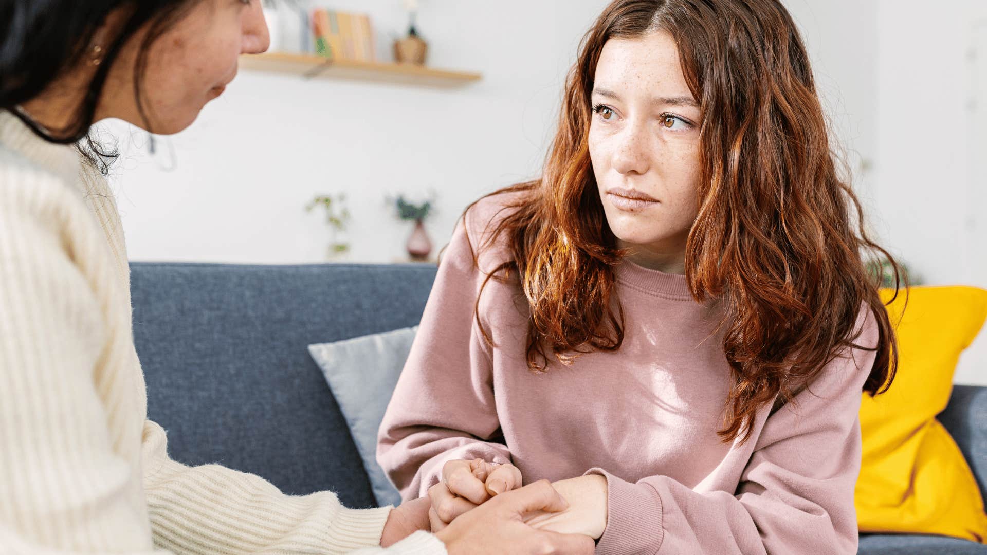 mom validating daughter's feeling and comforting her and daughter stares at mom