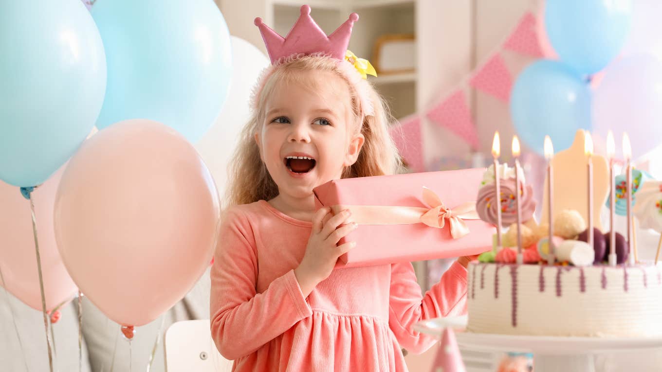 Little girl getting gifts on her sibling's birthday 