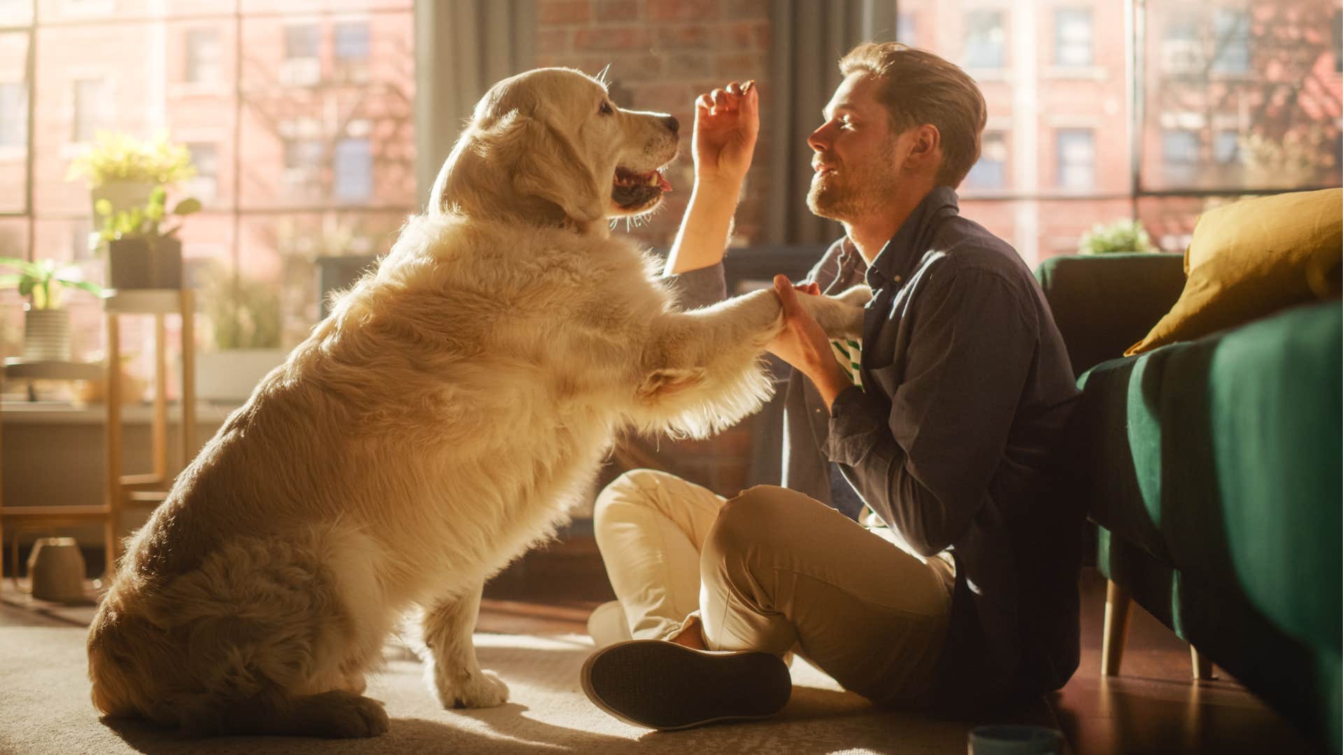 A man shares his snack with his dog