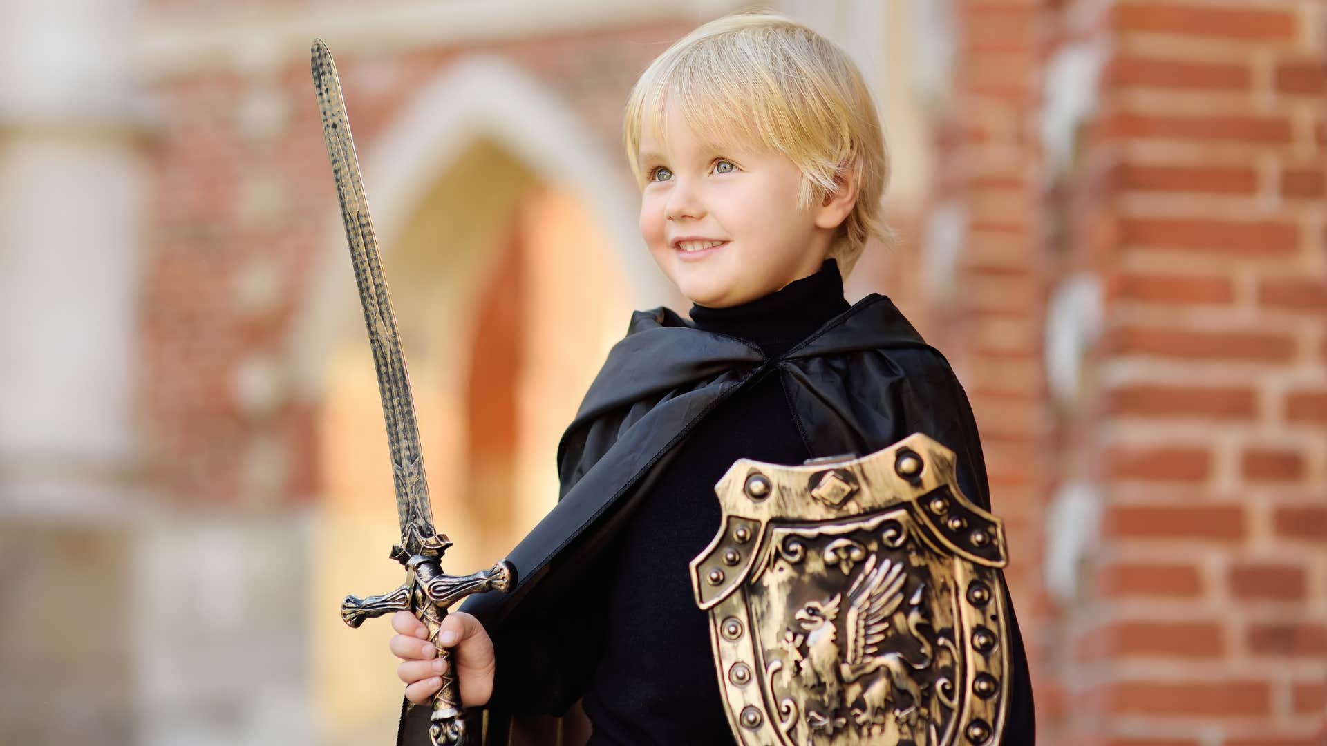 young boy dresses as a knight of the round table like King Arthur