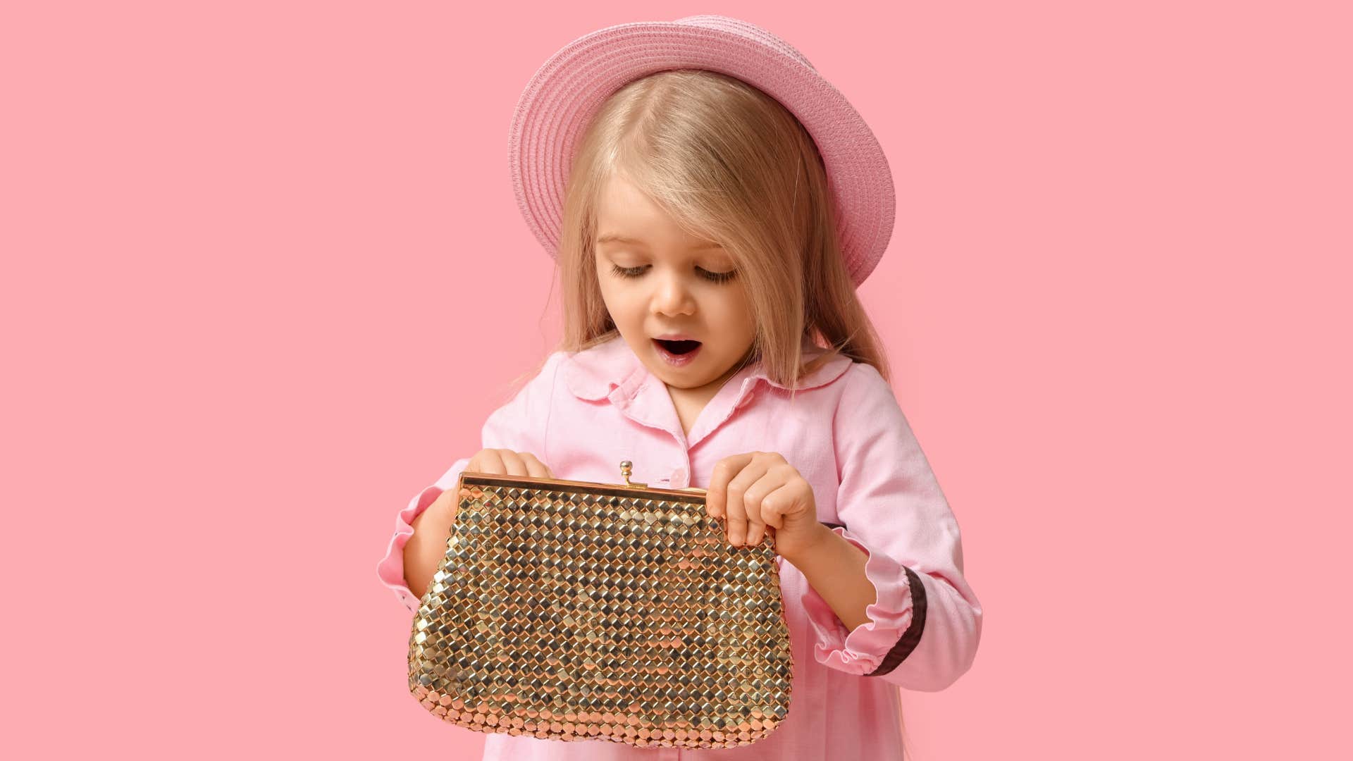 little girl holding gold purse looking shocked