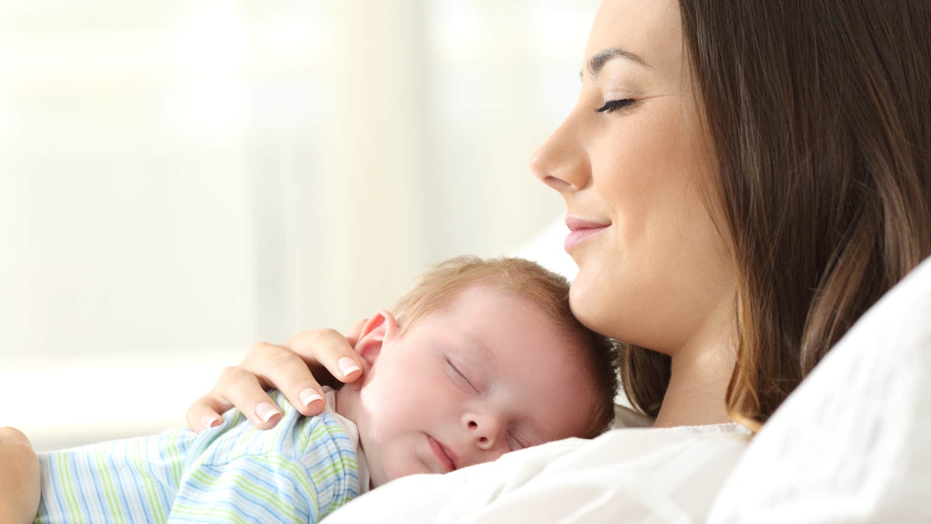 mother holding sleeping baby boy