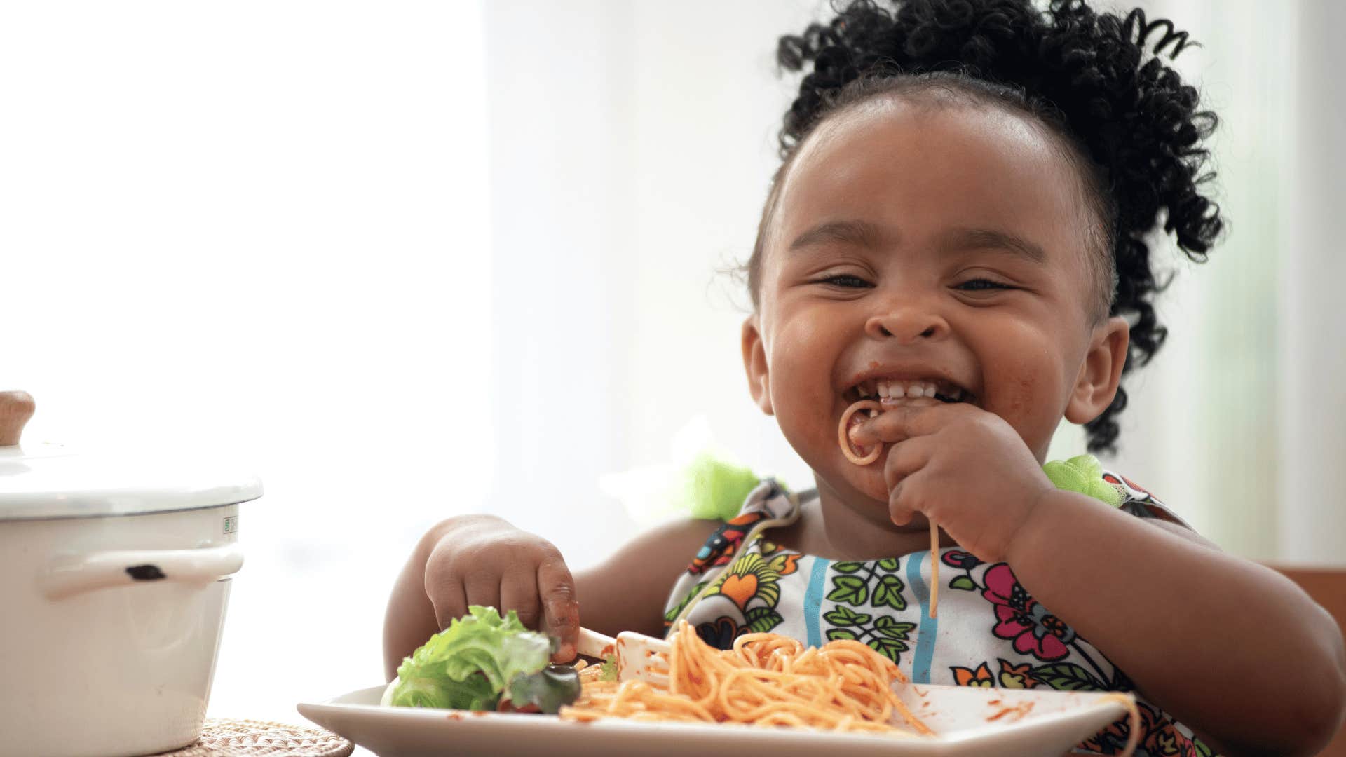 Happy child with full plate is parented well