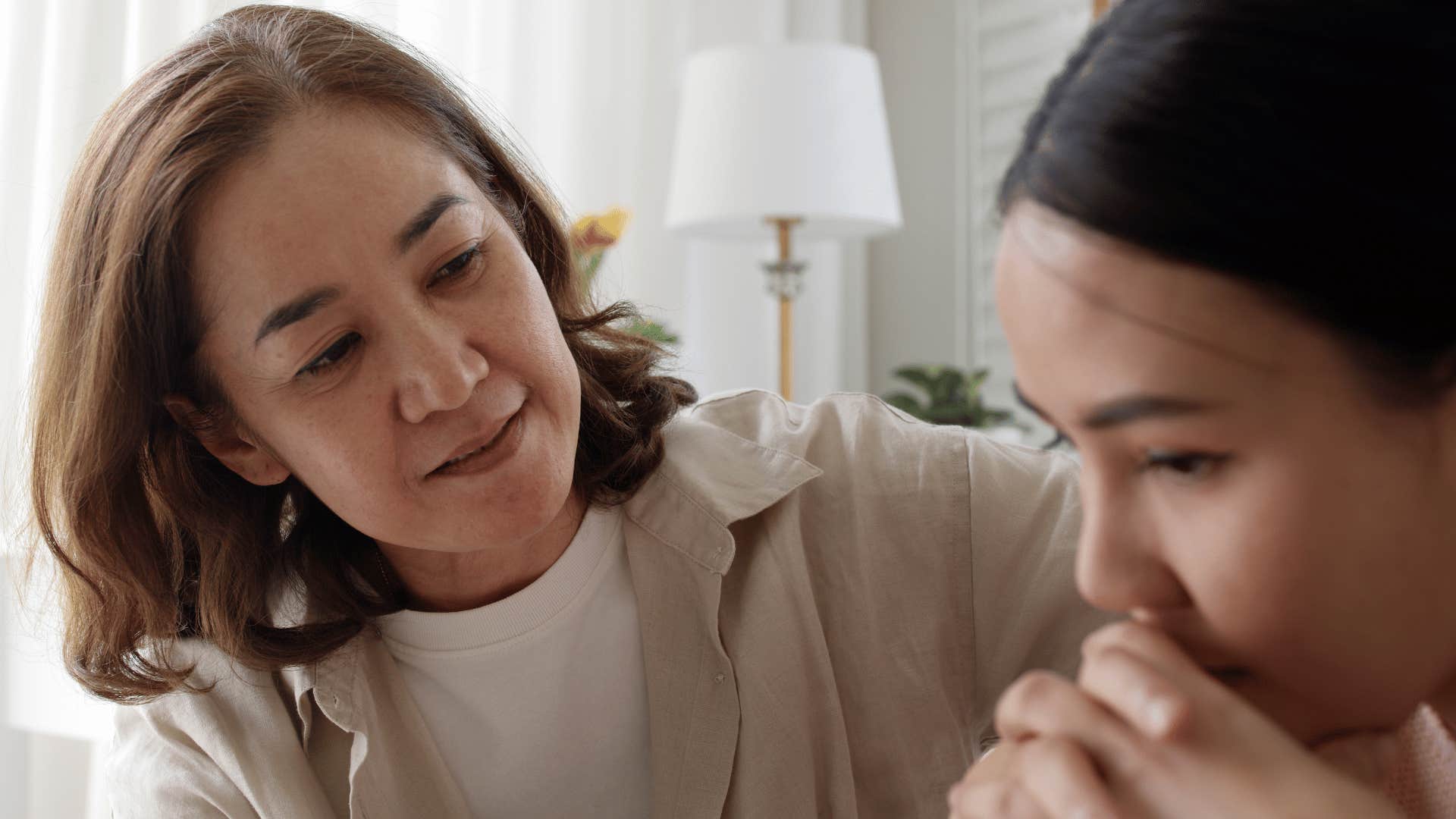 Mother parents child who is scared without being abusive