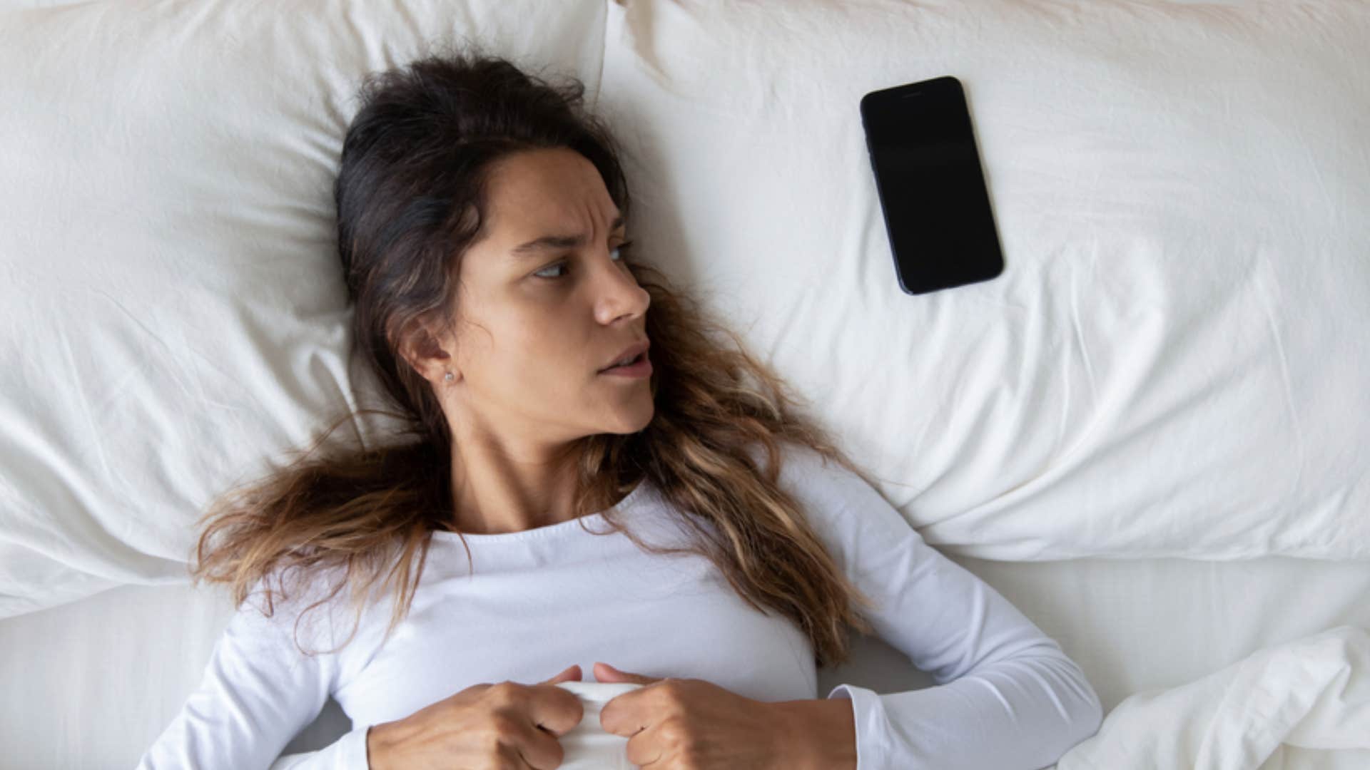 scared woman receiving a chain text message