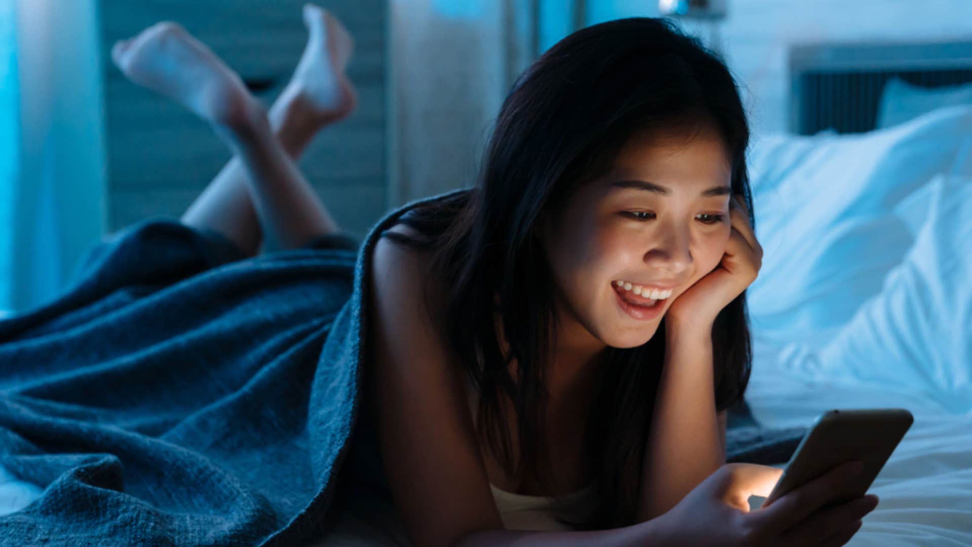 woman sending friend happy birthday text at midnight 