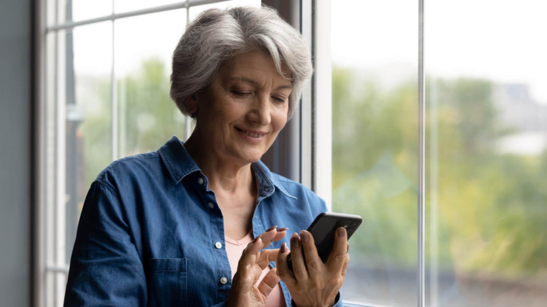 woman signing text message with her name 