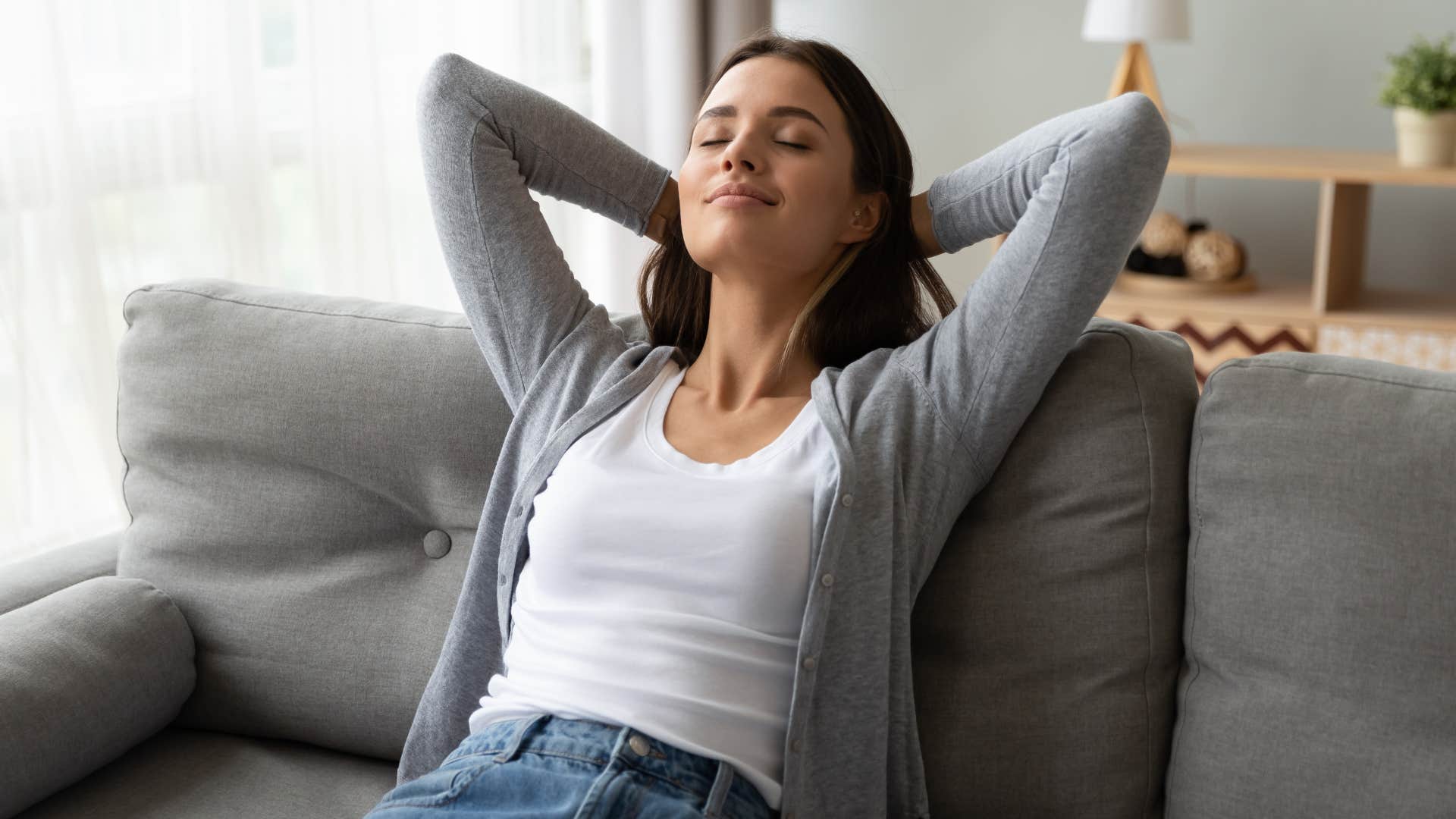woman with gray shirt relaxing as she feels safe at home 