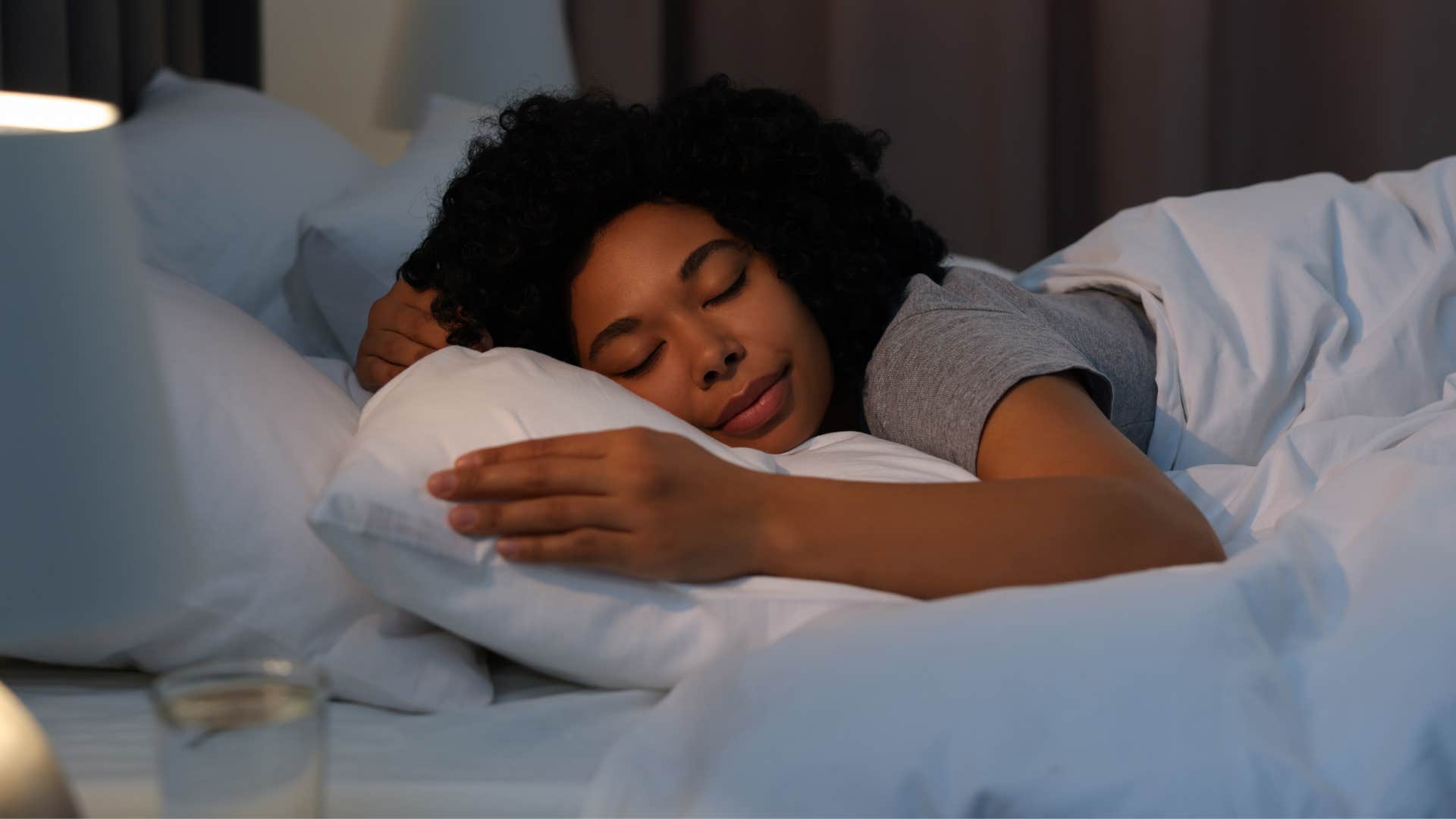 woman recharging her energy as she sleeps in bed