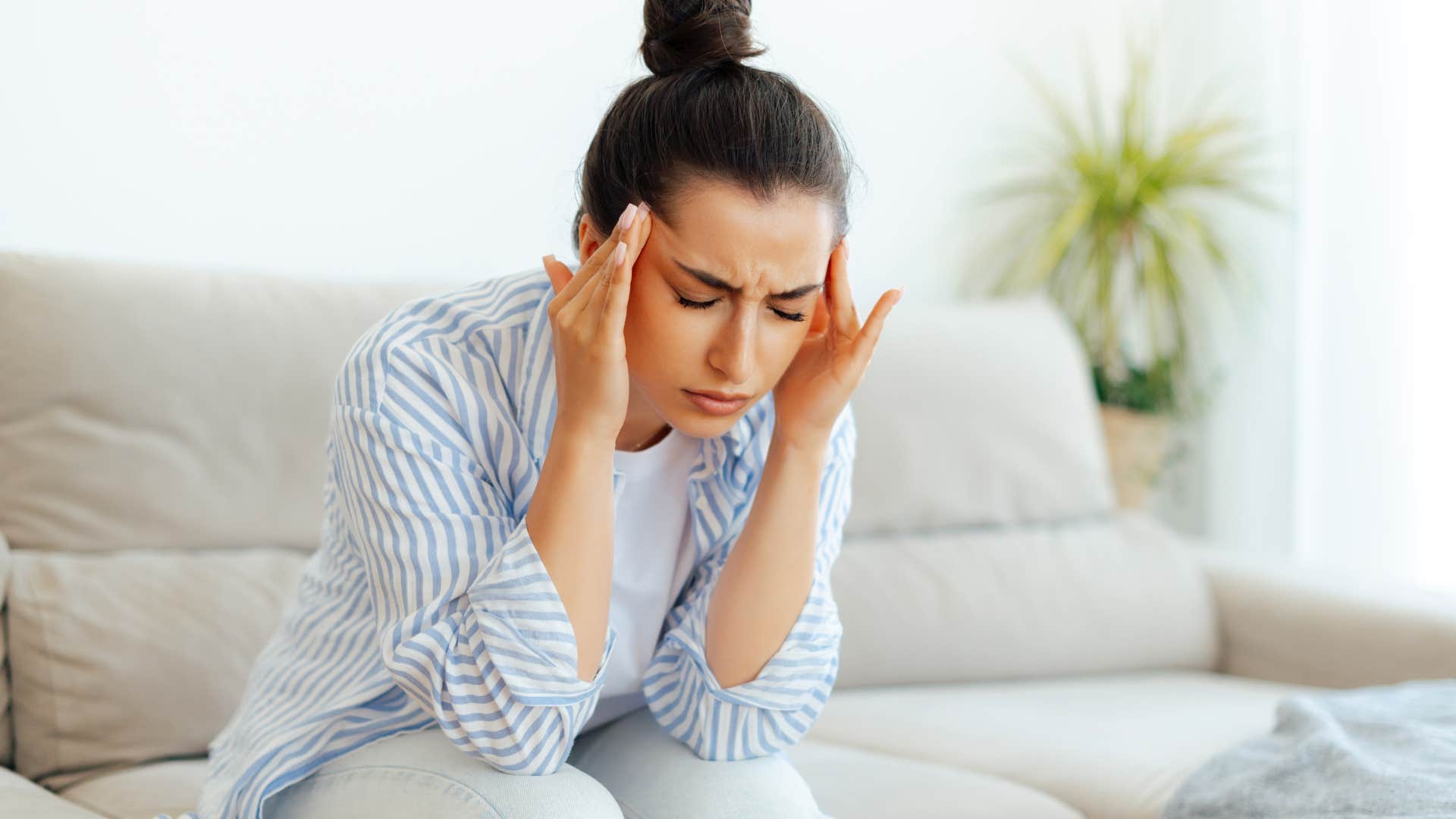 woman with headache not feeling well after socializing