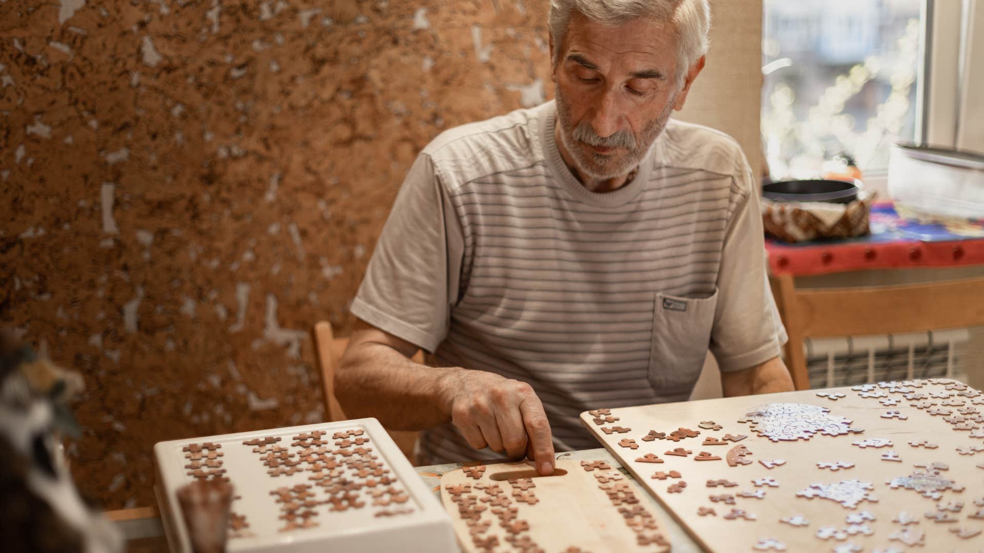 man unwinding by doing puzzles to recover from socializing
