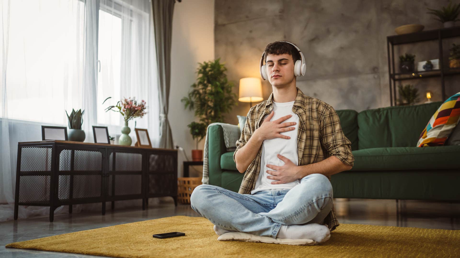 man practicing self-care by meditating