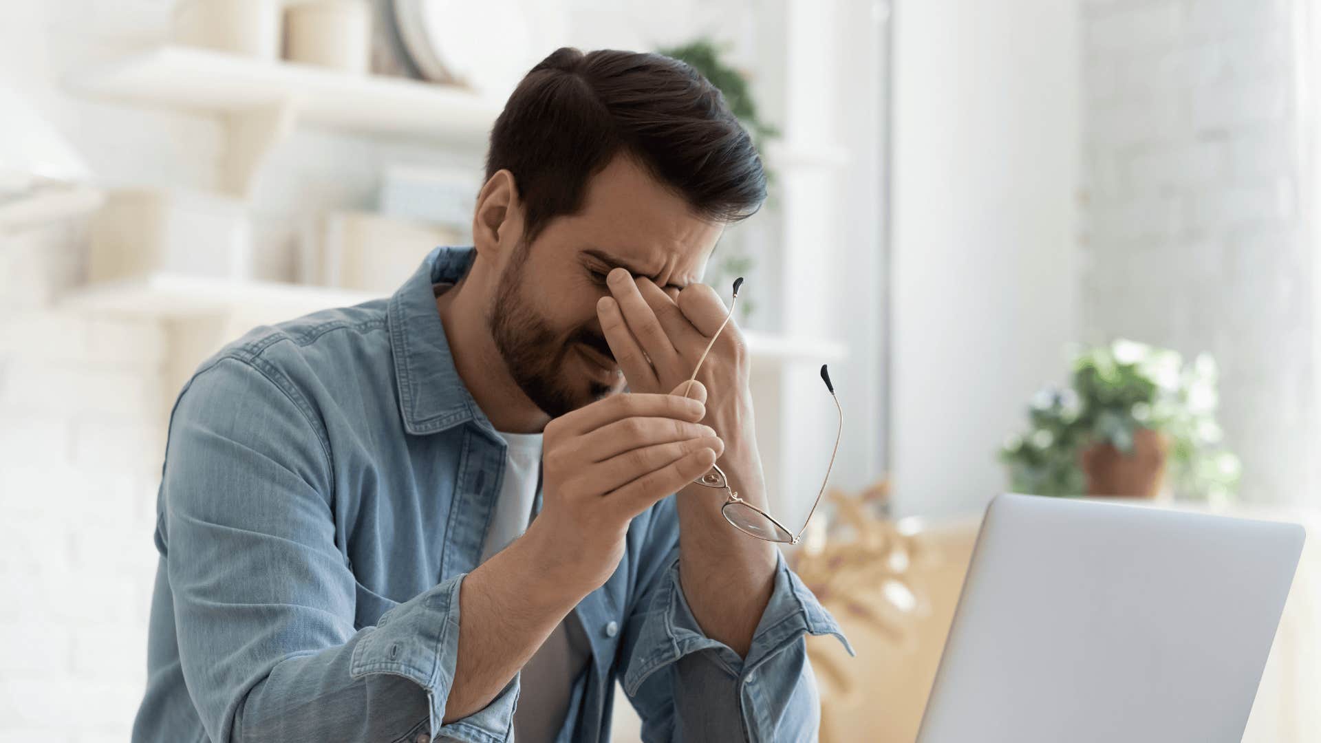 upset man in front of computer who was raised by emotionally immature parents