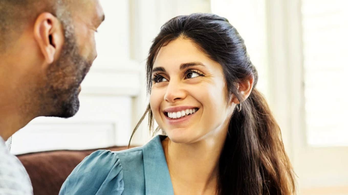 Brilliant woman smiling at man after regaining control in her relationship 