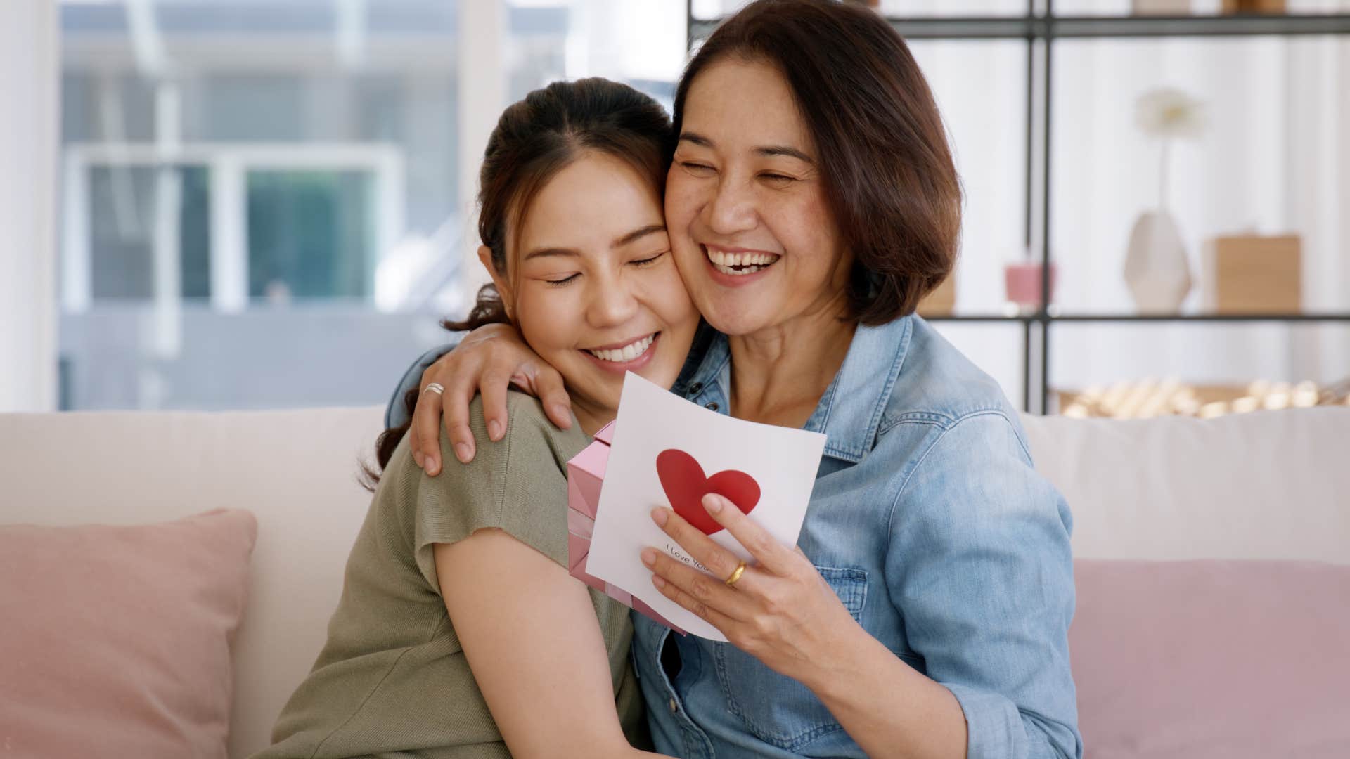 Adult woman and her mother smiling while spending quality time together.
