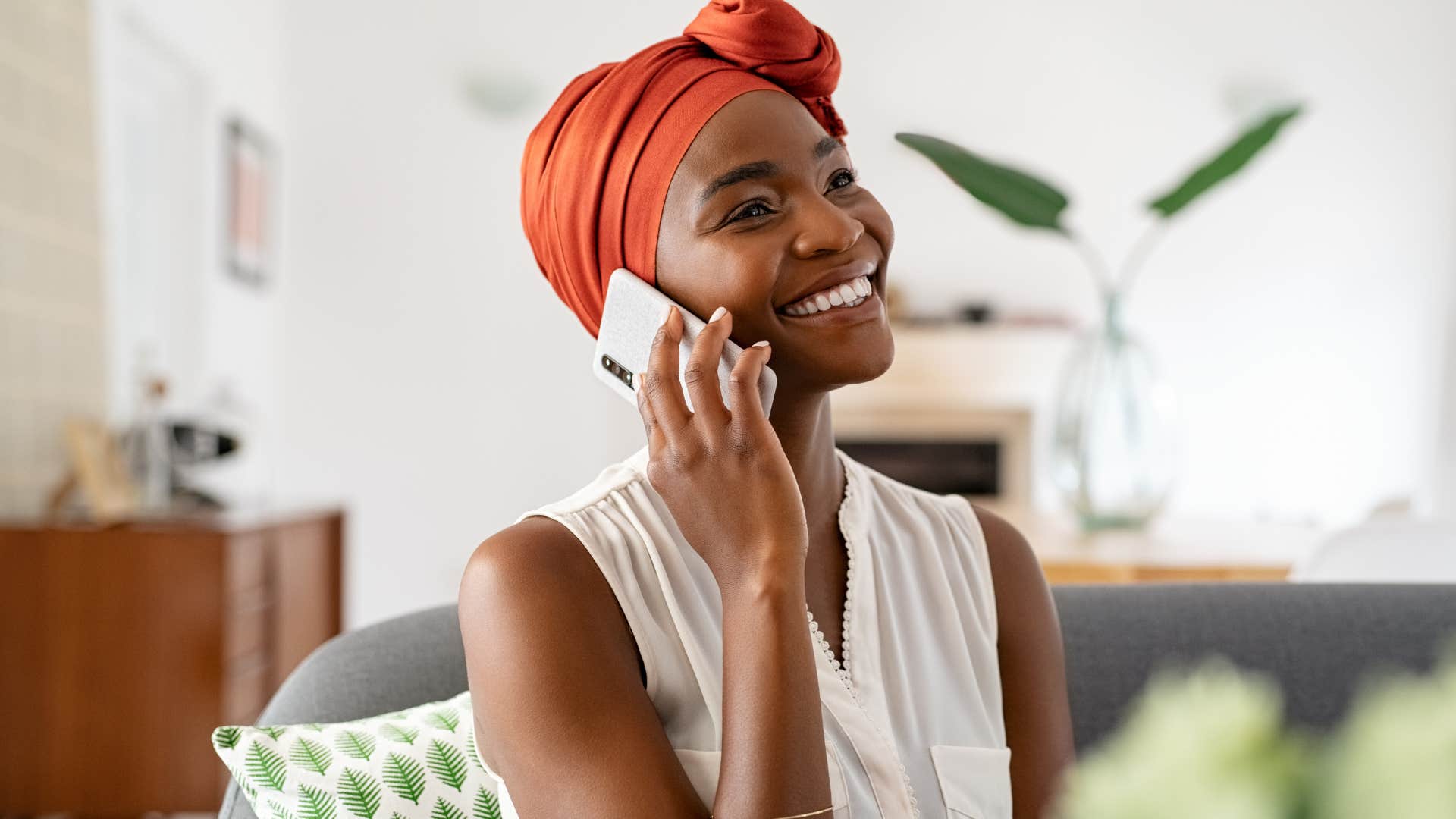 Woman who feels supported, rather than judged smiling and talking on the phone.
