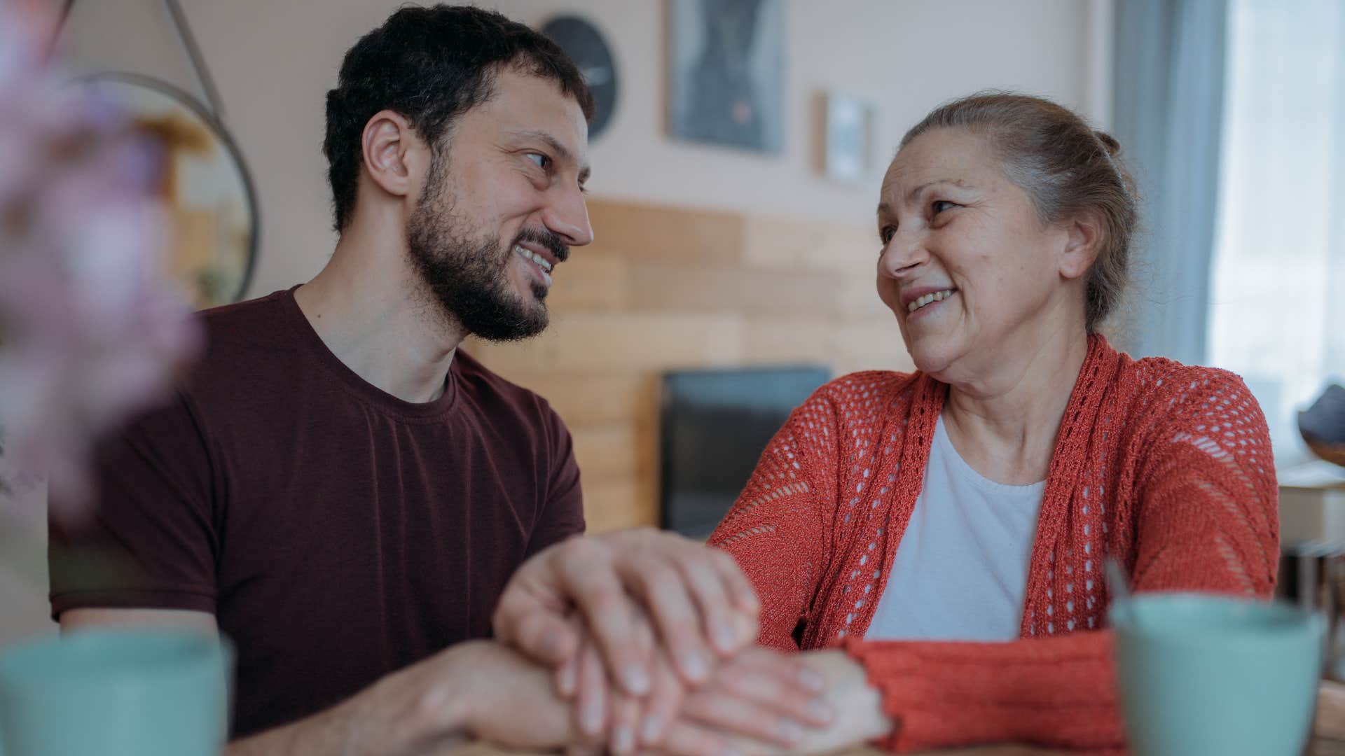 Woman who waits to offer advice until they're asked smiling at their adult son.