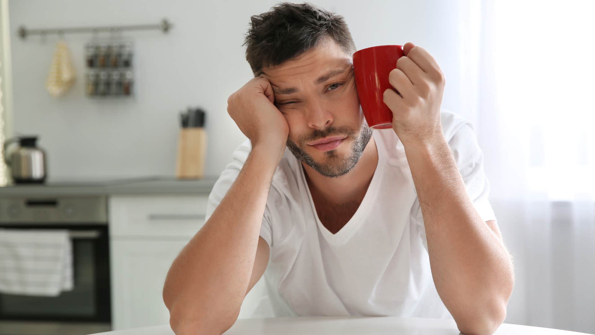 man looking tired day after drinking too much caffeine