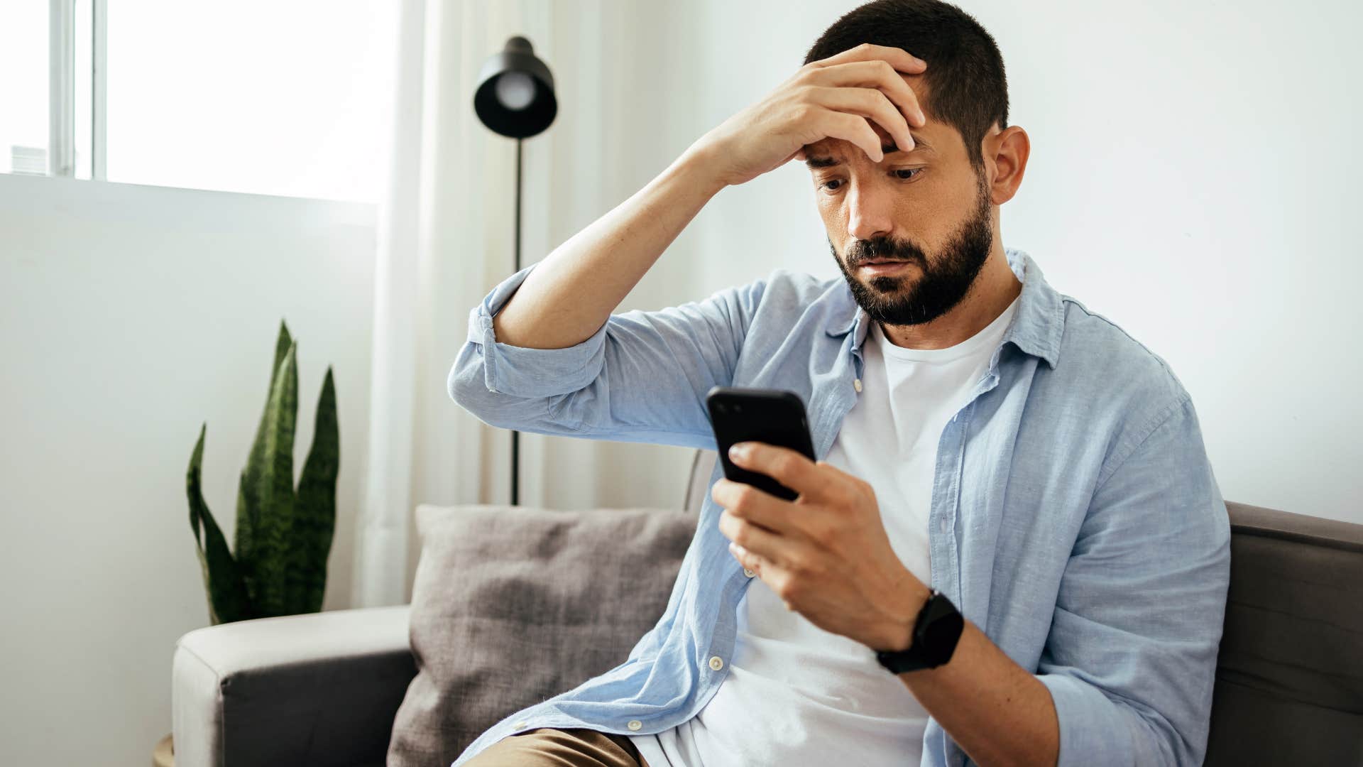 annoyed man looking at phone tired of his fake friends