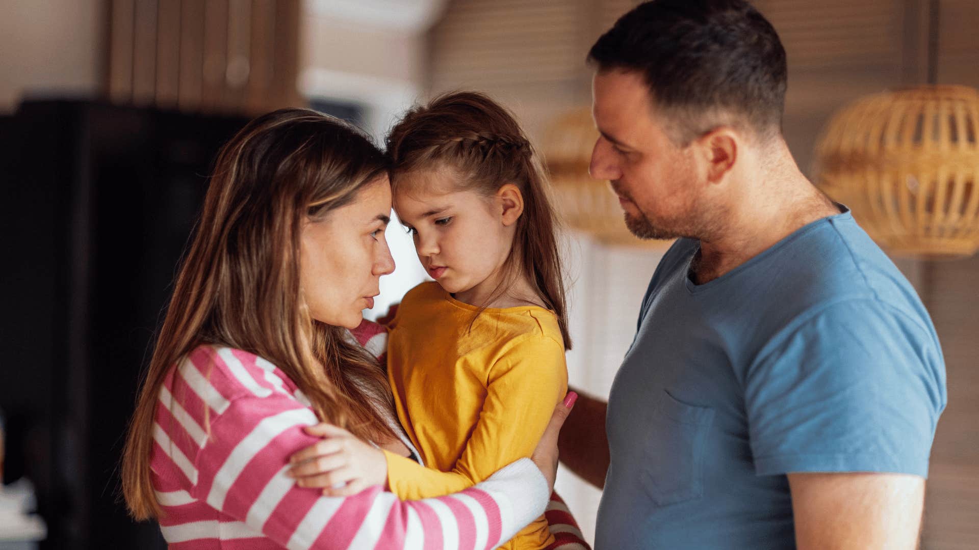 parents comforting child 