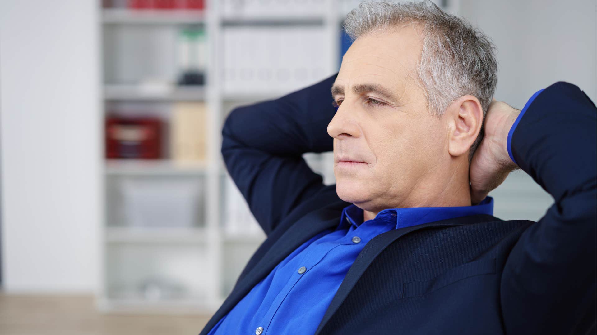 Man who's confident in their experience sitting in his office.
